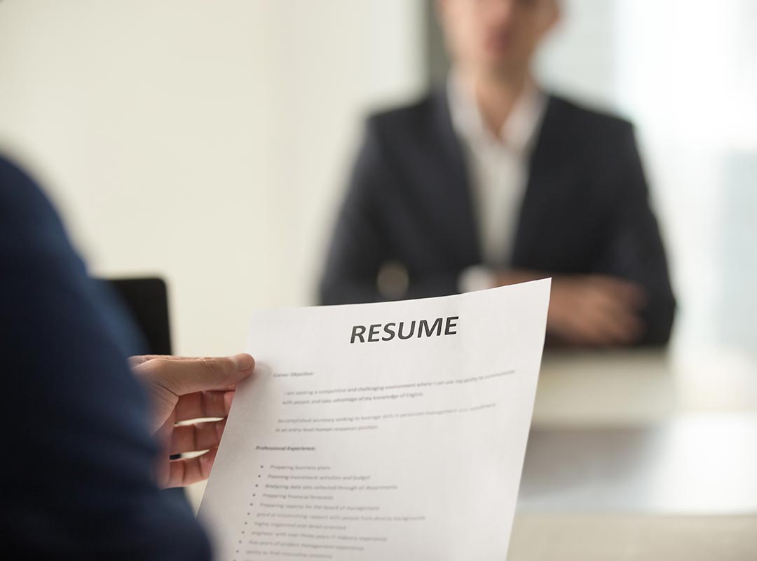 A person reading a resume